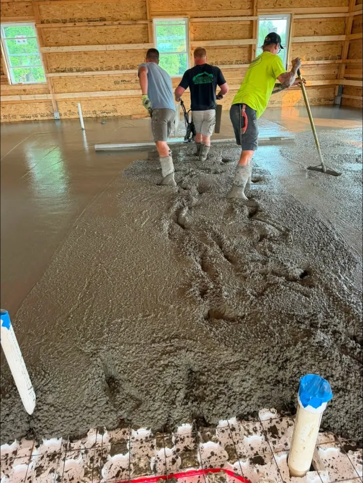 Crew screeding a floor poured over radiant heat tubing