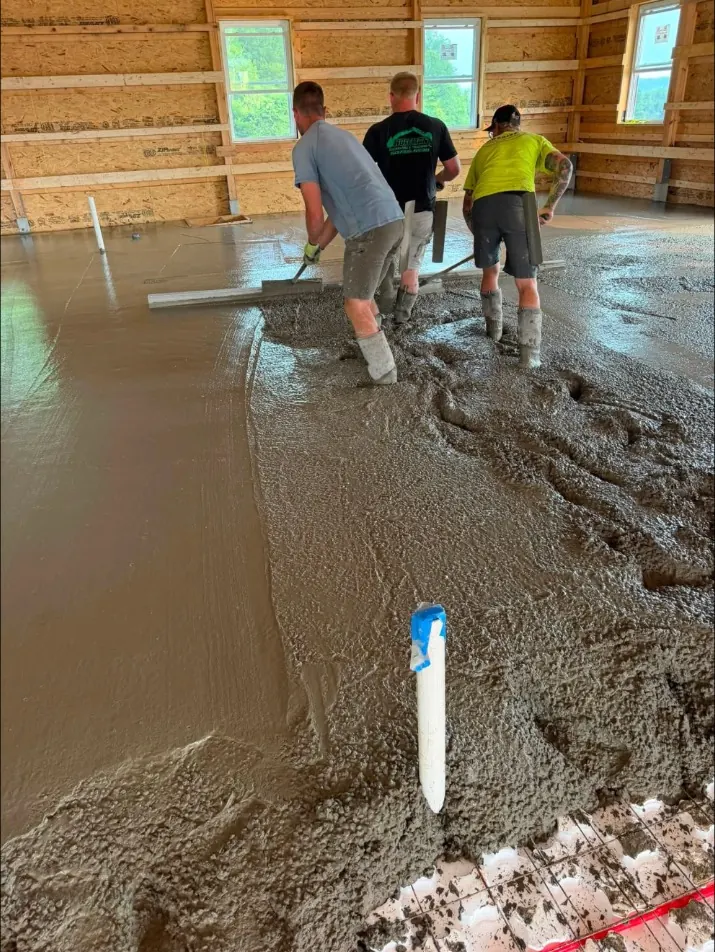 Concrete being placed over radiant heat tubing and insulation board