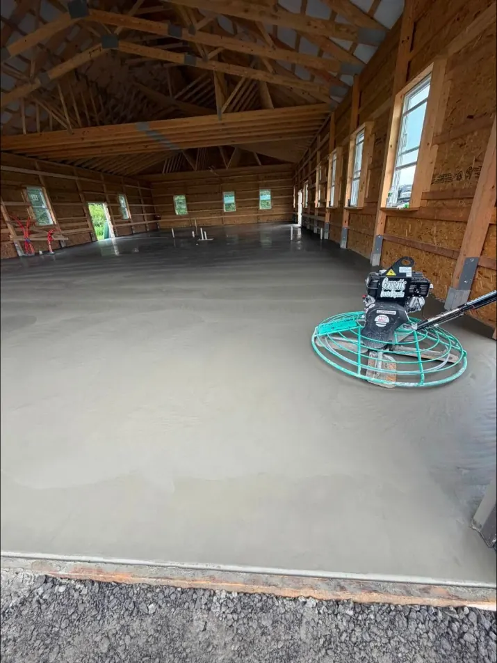 Walk-behind power trowel on a barndominium floor