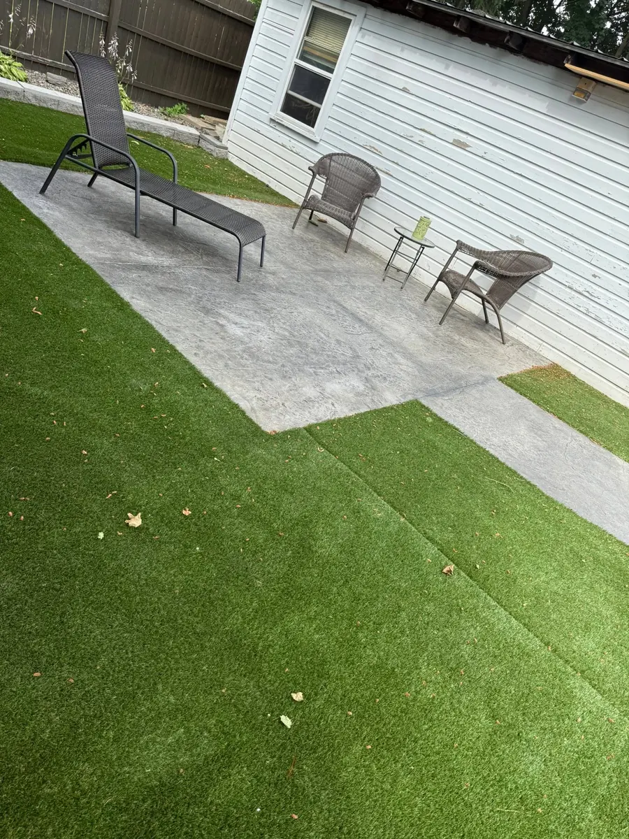 Broom finish patio beside new turf
