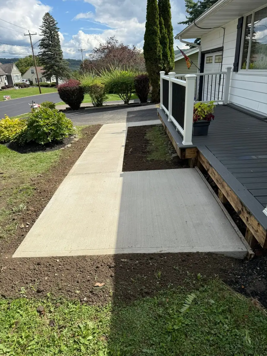 New broom finish front walkway beside a porch