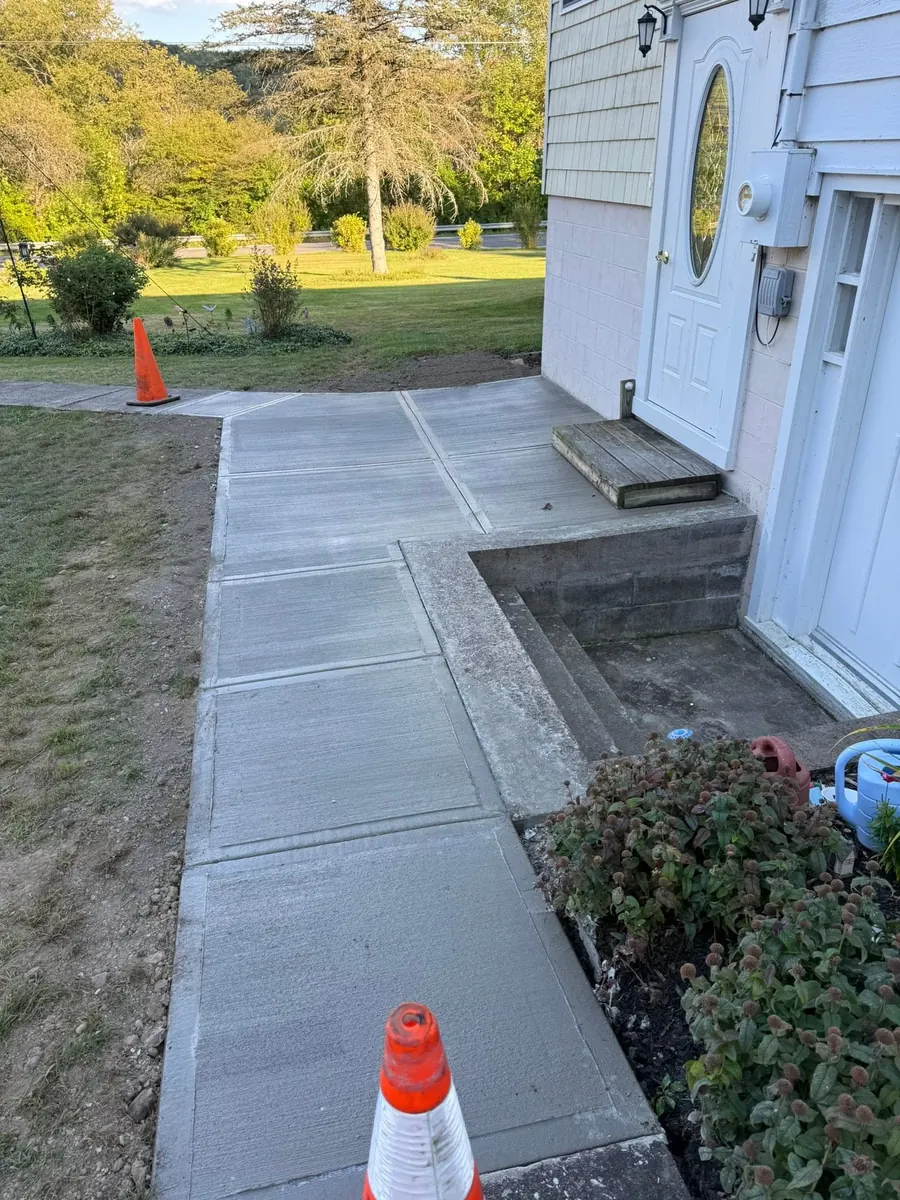 Long broom finish sidewalk along the side of a house