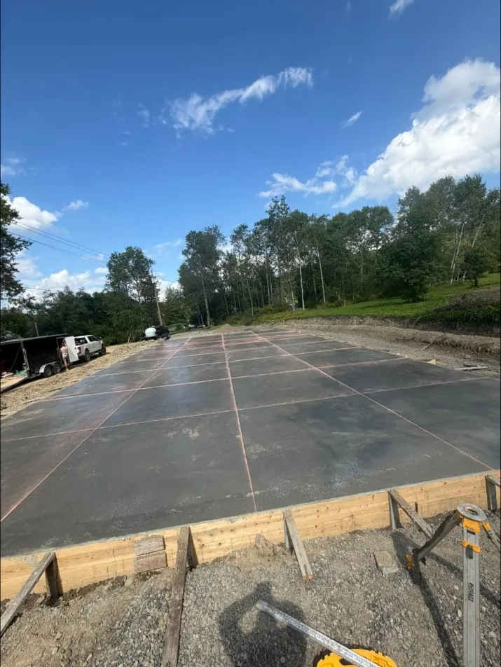 Finished slab with saw cut control joints, forms still in place