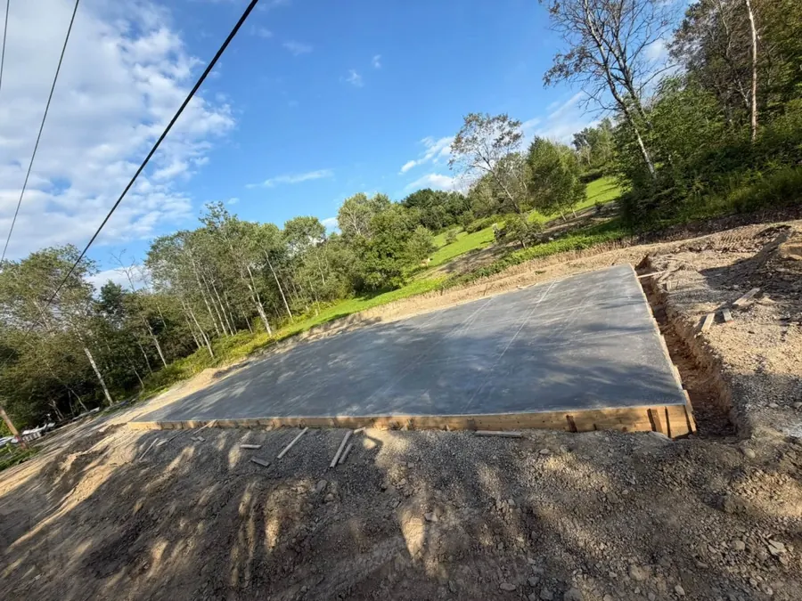 Finished slab inside its forms on a hillside lot