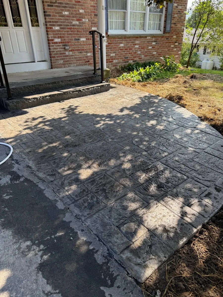Ashlar slate stamped patio outside a brick house