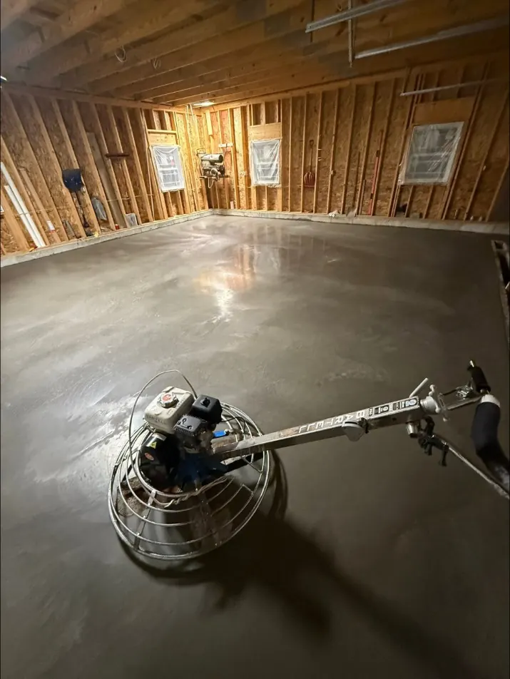 Power trowel on a new garage floor in Verona, NY