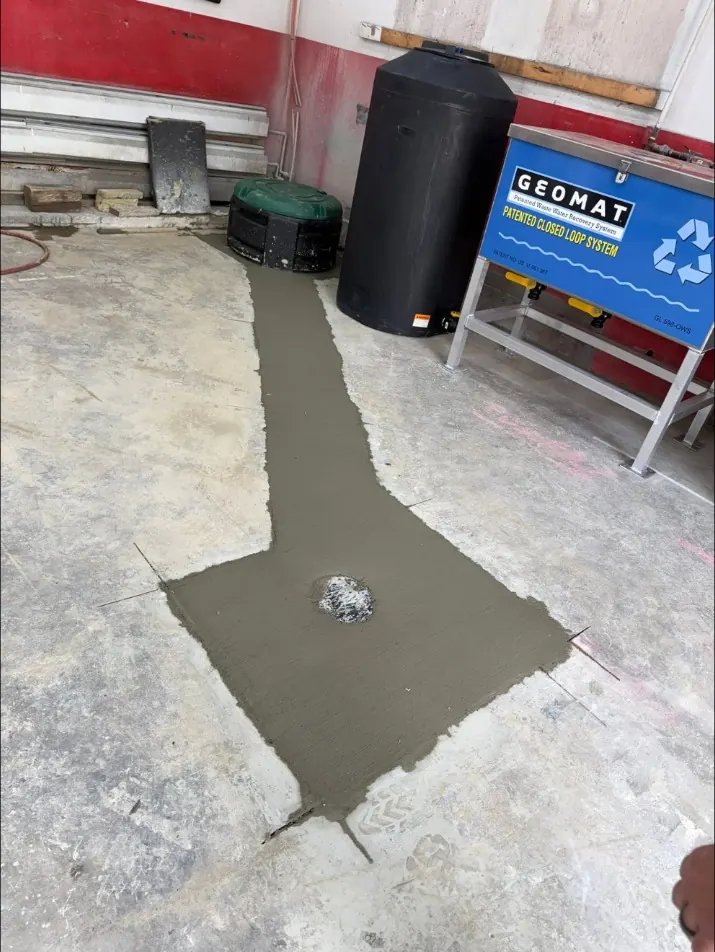 Shop floor trench patched with new concrete beside the new filtration system